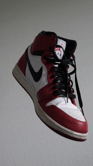 A sneaker turning against a plain background — Before